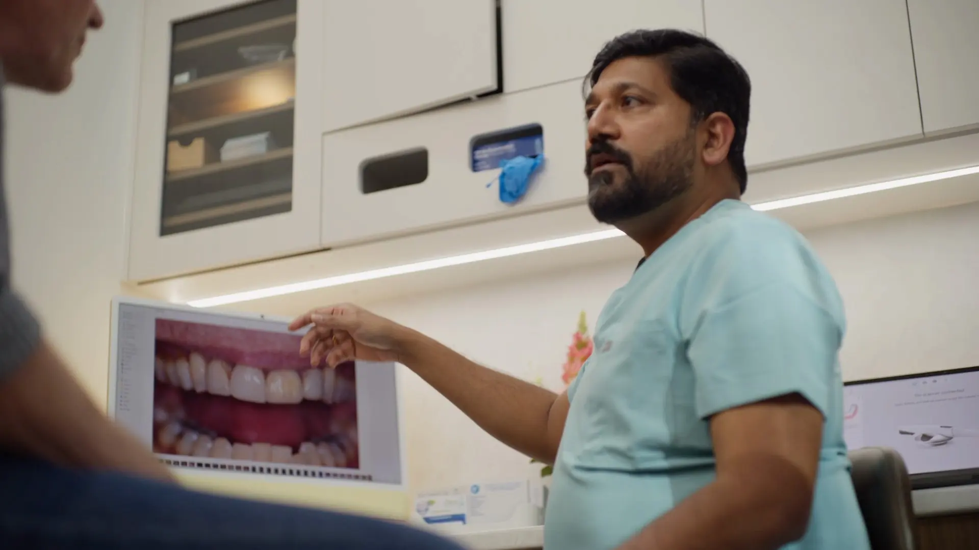 Dr Sri pointing at a smile photo on screen